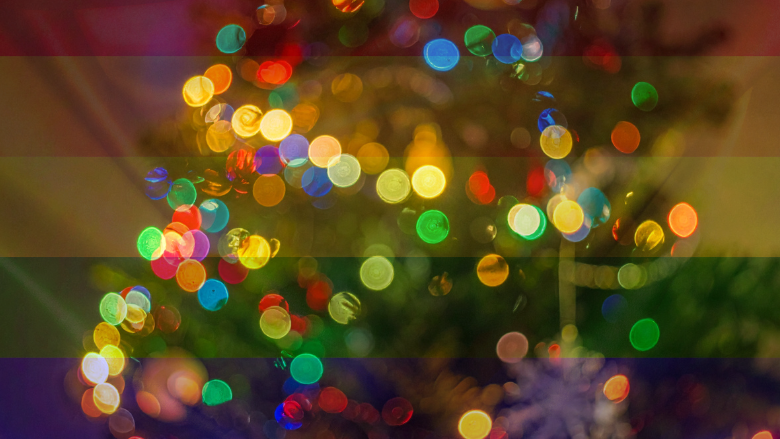 Rainbow holiday lights symbolizing pride and inclusivity at a festive LGBTQ community event
